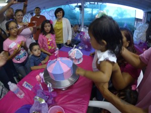 1 year old Xemma blows out a candle on her purple & pink cake!